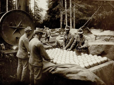 Austro-Hungarian artillerymen grease the ball bearings for the race ring of the massive 42 cm L15 Coastal Howitzer M 14 16 turntable carriage, 18 August 1916.jpg